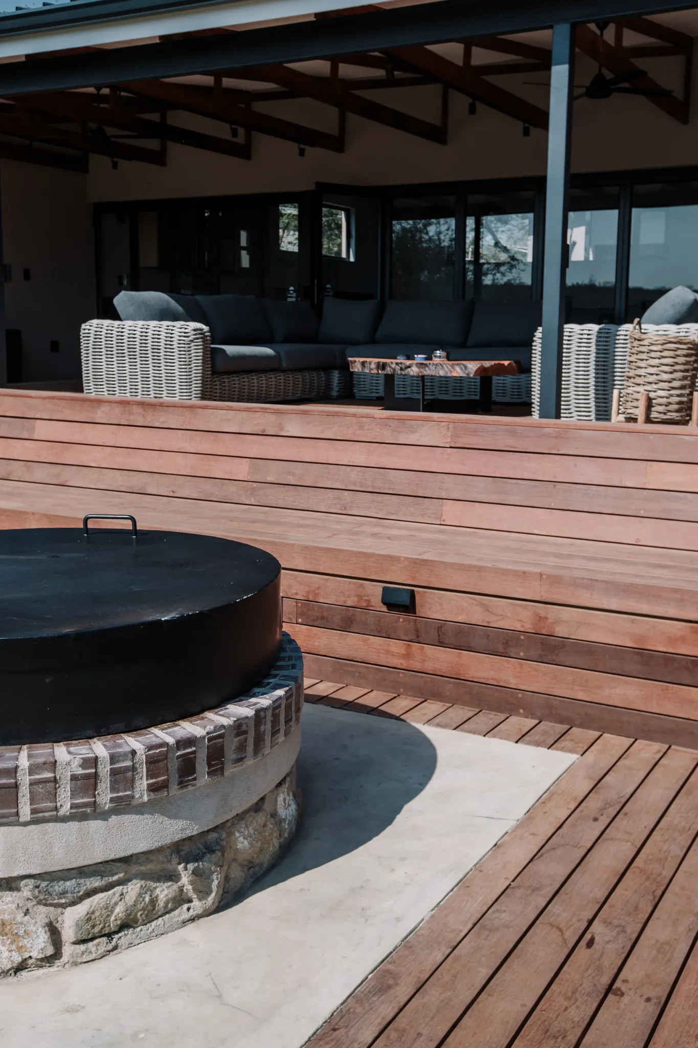 A covered patio with a built in fireplace.